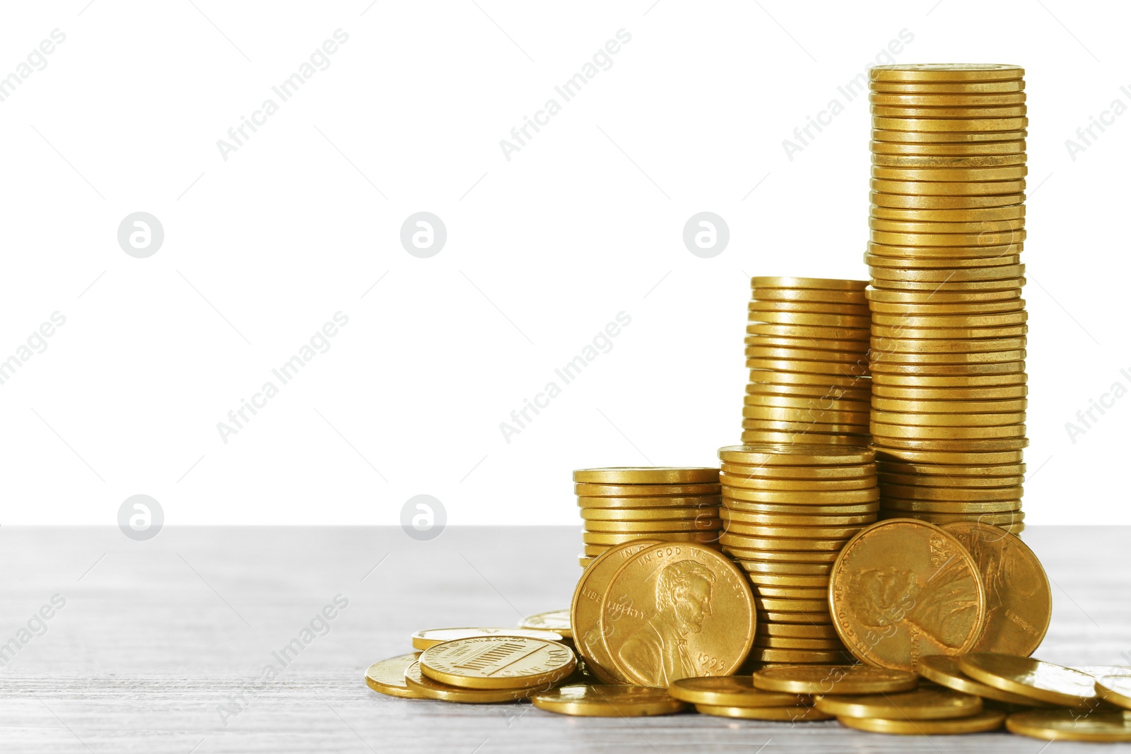 Photo of Stack of coins on wooden table. Space for text