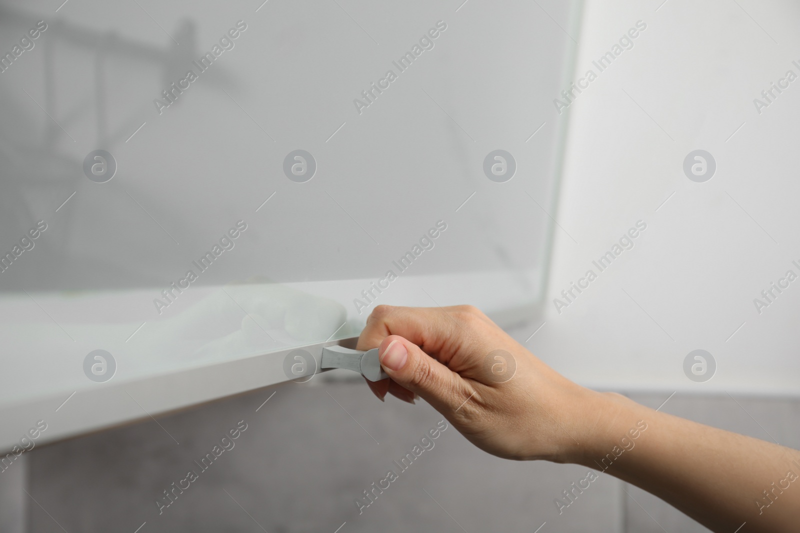 Photo of Woman opening cabinet door at home, closeup