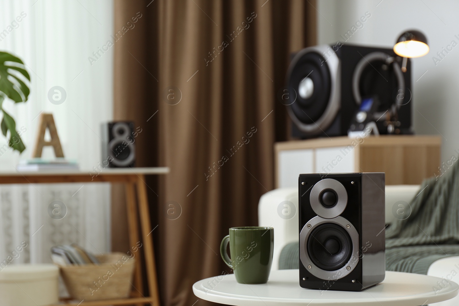 Photo of Modern powerful audio speaker system in bright room