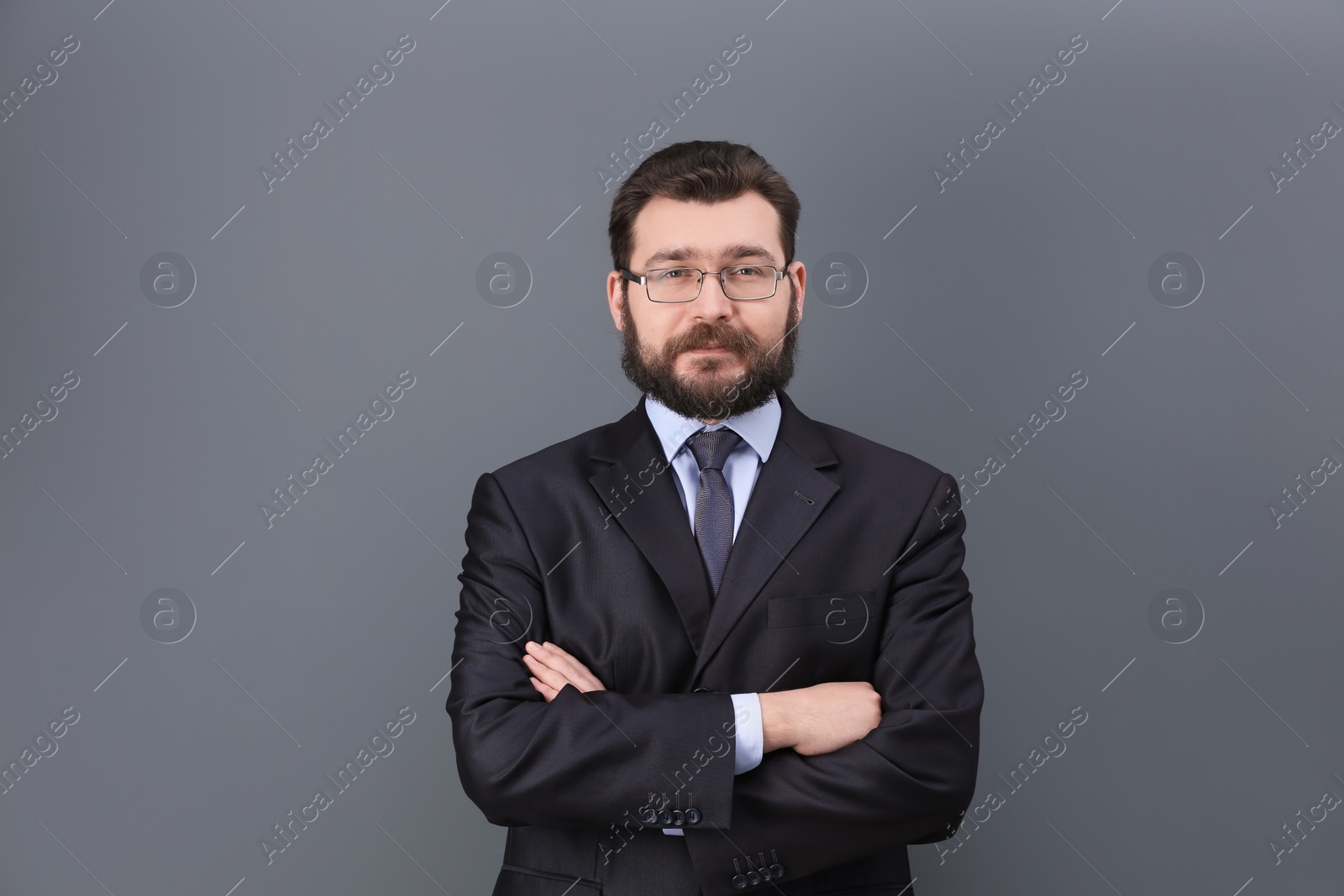 Photo of Portrait of confident mature man in elegant suit on color background