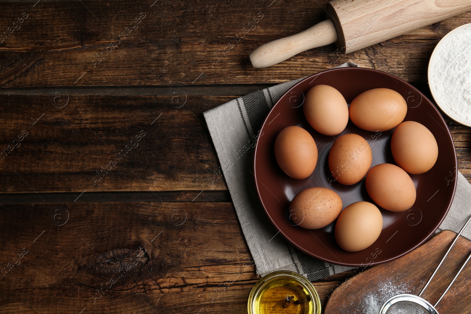 Photo of Flat lay composition with chicken eggs on wooden table. Space for text