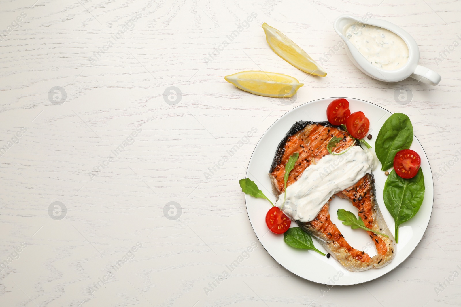 Photo of Tasty salmon steak on white wooden table, flat lay. Space for text