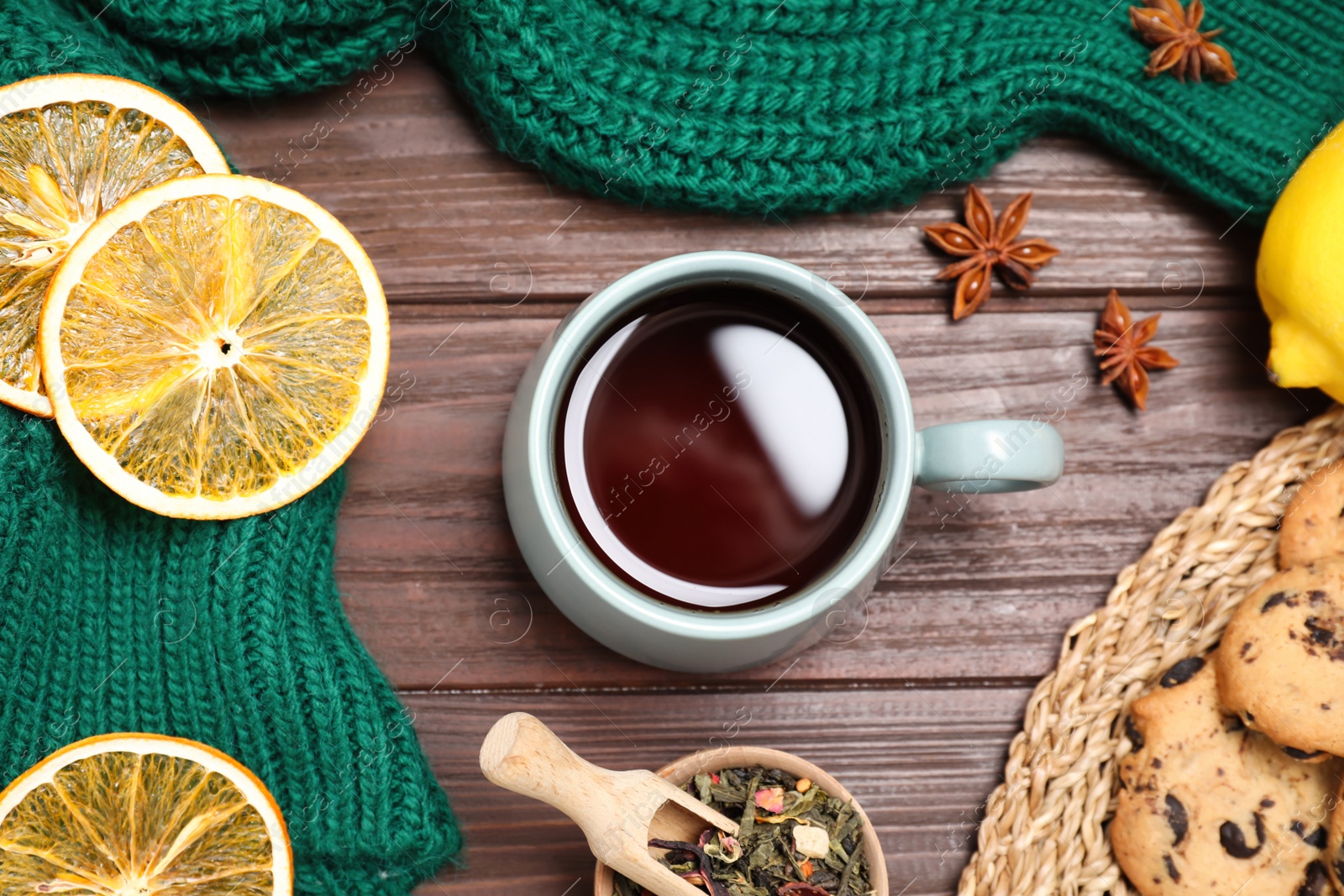 Photo of Flat lay composition with tasty tea in cup on wooden table