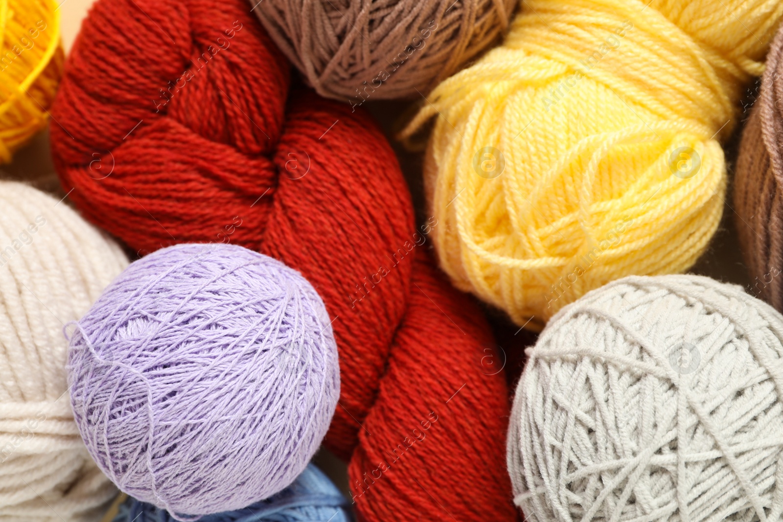 Photo of Soft colorful woolen yarns as background, closeup