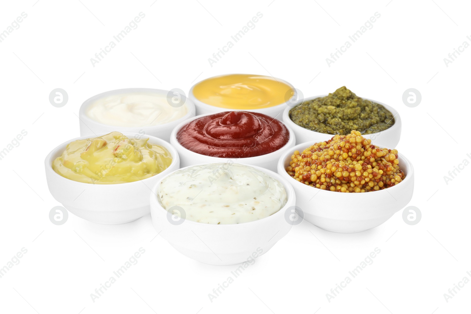 Photo of Many different sauces in bowls on white background