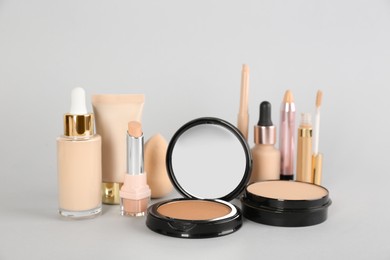 Photo of Foundation makeup products on light background. Decorative cosmetics