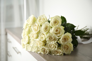 Photo of Luxury bouquet of fresh roses on commode