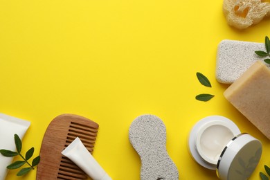 Flat lay composition with pumice stones on yellow background. Space for text