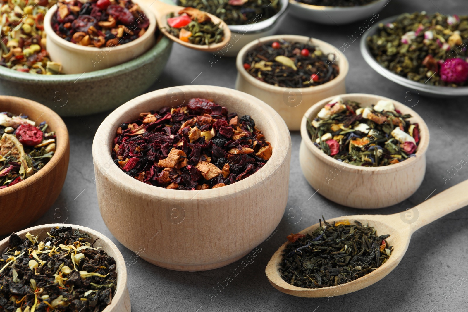 Photo of Many different herbal teas on grey table