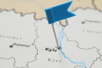 Photo of MYKOLAIV, UKRAINE - NOVEMBER 09, 2020: Kyiv city marked with flag push pin on contour map of Ukraine, closeup