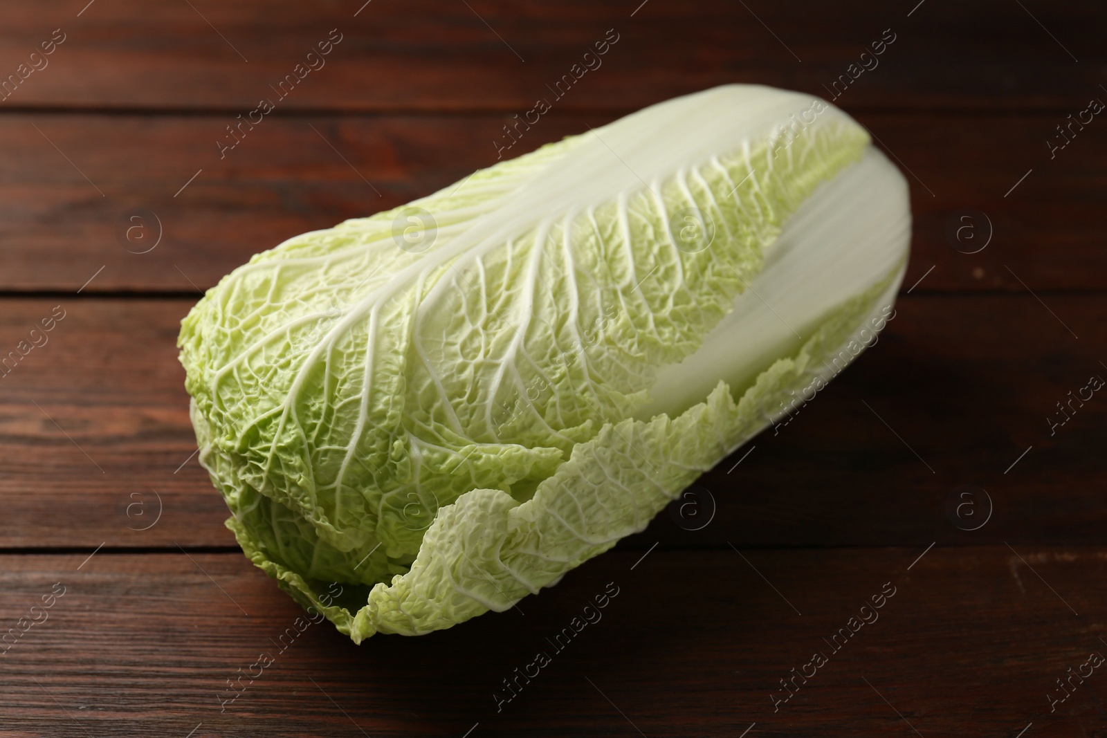 Photo of Fresh ripe Chinese cabbage on wooden table