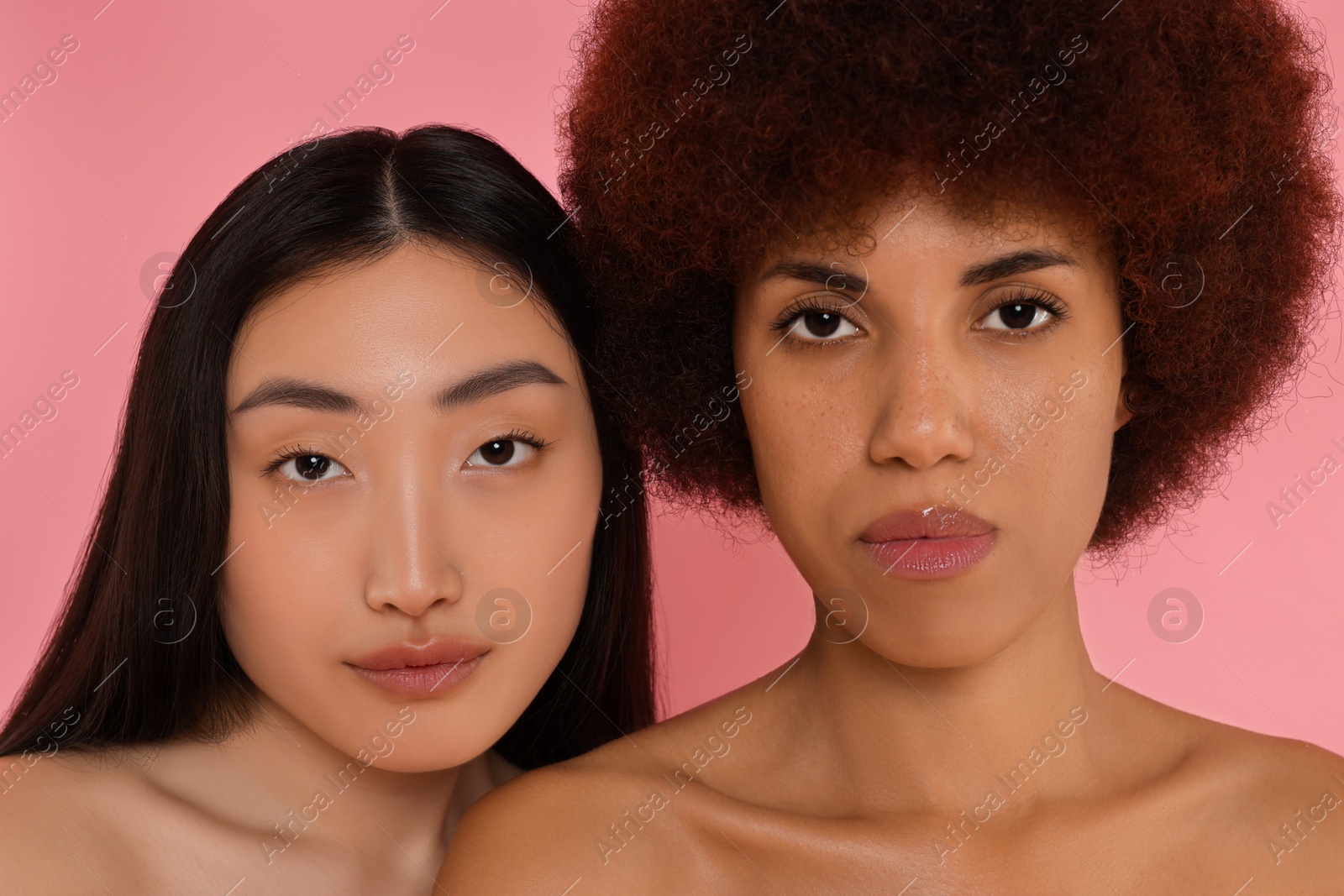 Photo of Portrait of beautiful young women on pink background