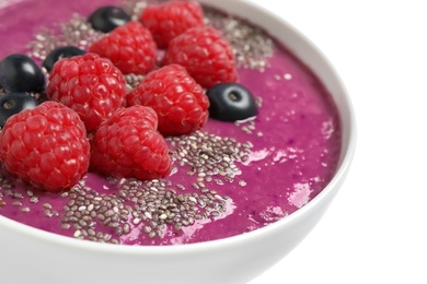 Healthy breakfast with delicious acai smoothie and fruits in bowl on white background, closeup