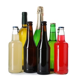 Bottles with different alcoholic drinks on white background