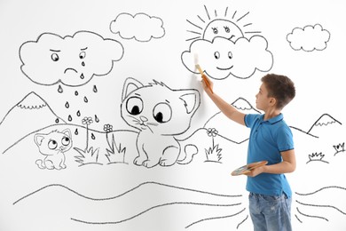 Image of Cute little boy drawing on white background