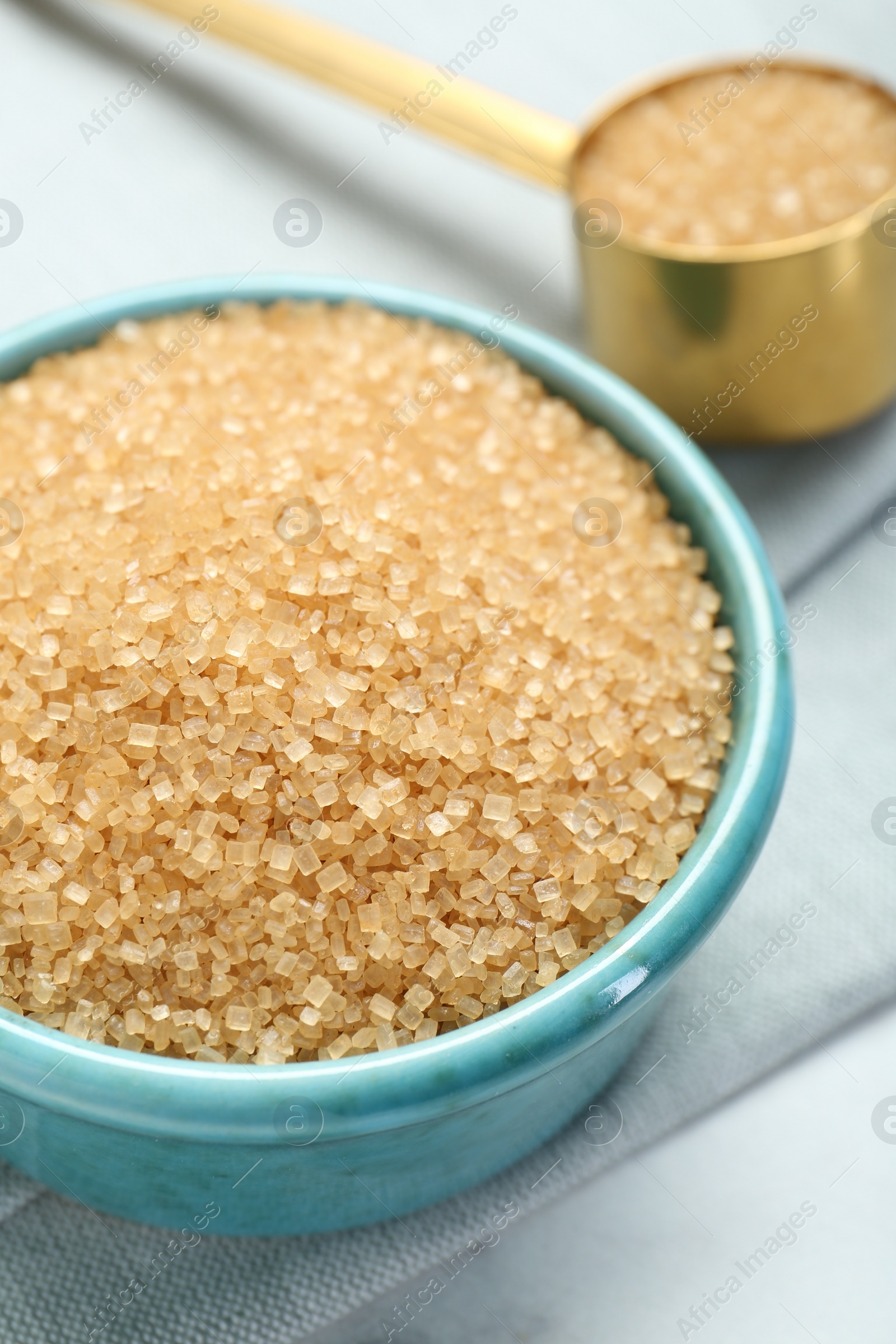 Photo of Brown sugar in bowl on table, closeup