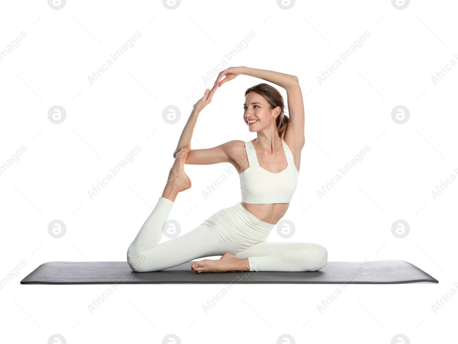 Photo of Young woman in sportswear practicing yoga on white background