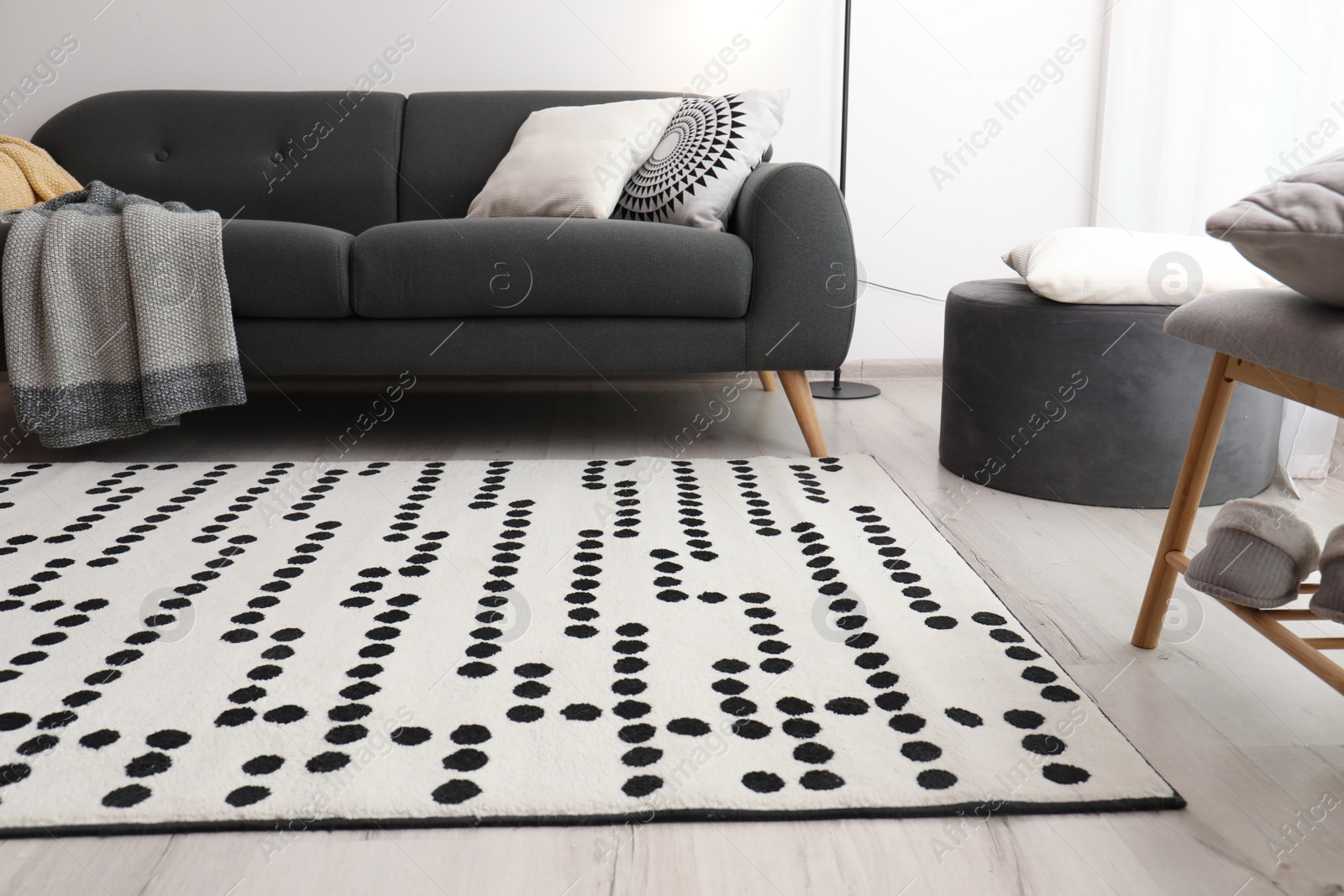 Photo of Living room interior with comfortable sofa and stylish rug