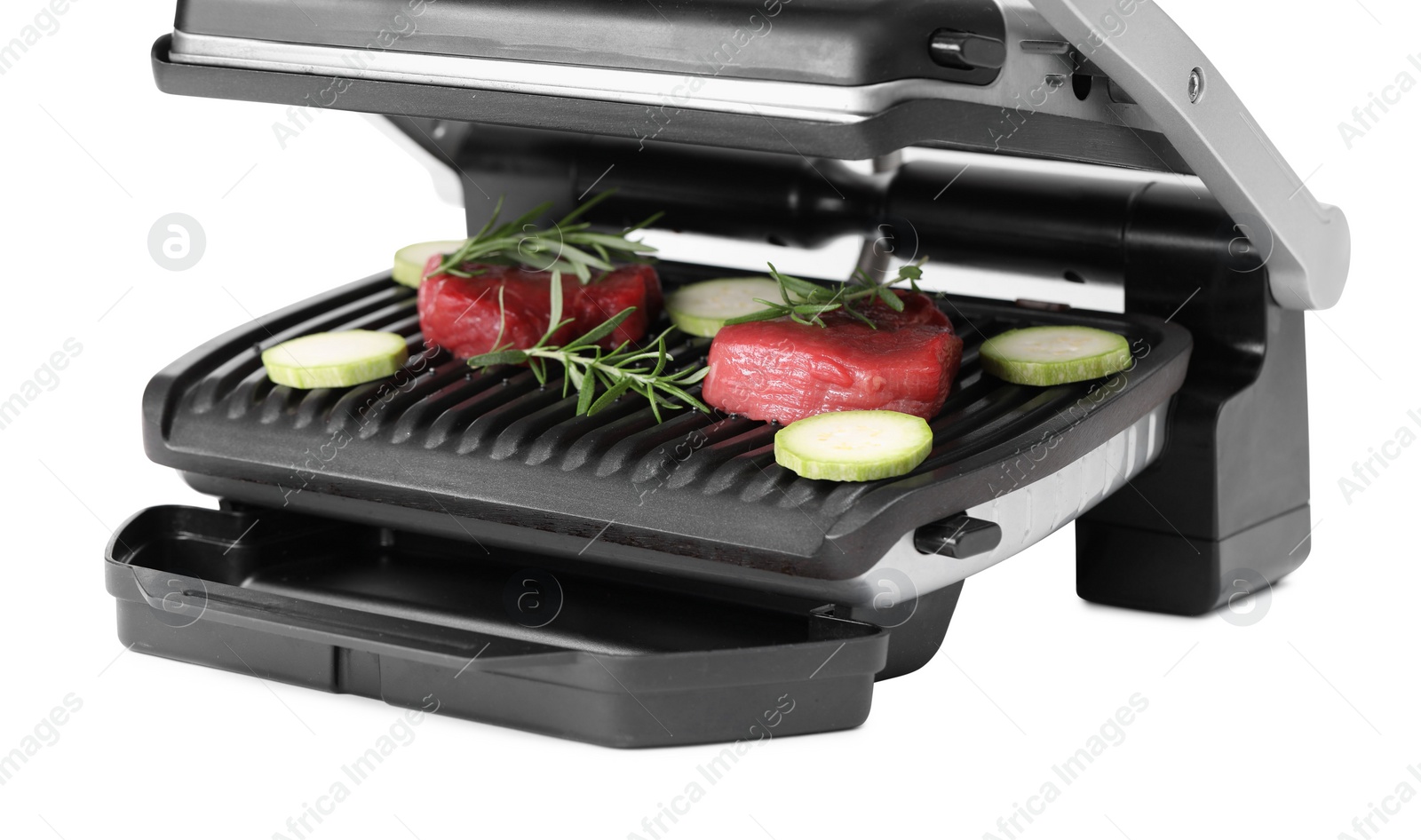 Photo of Electric grill with raw meat, zucchini and rosemary isolated on white