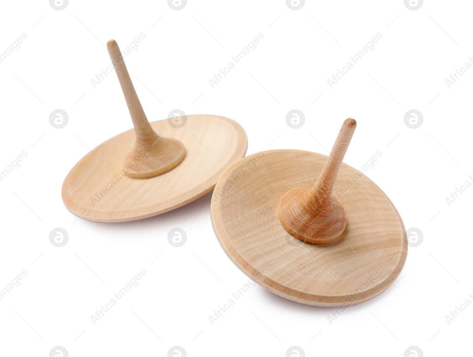 Photo of Two wooden spinning tops isolated on white