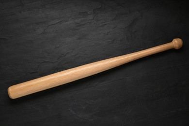 Photo of Baseball bat on black background, top view. Sports equipment