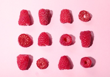 Flat lay composition with delicious ripe raspberries on pink background