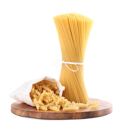 Photo of Wooden board with spaghetti and fusilli pasta isolated on white