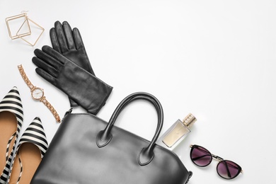 Photo of Flat lay composition with stylish black leather gloves, shoes and accessories on white background. Space for text