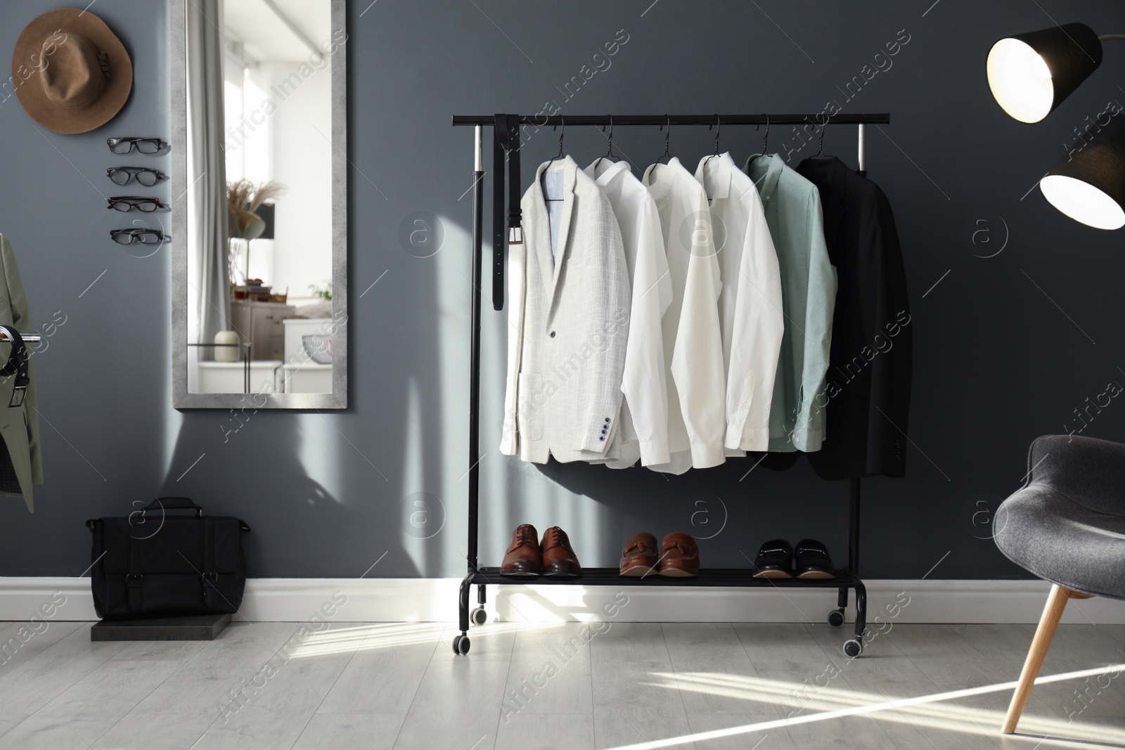 Photo of Dressing room interior with clothing rack and mirror