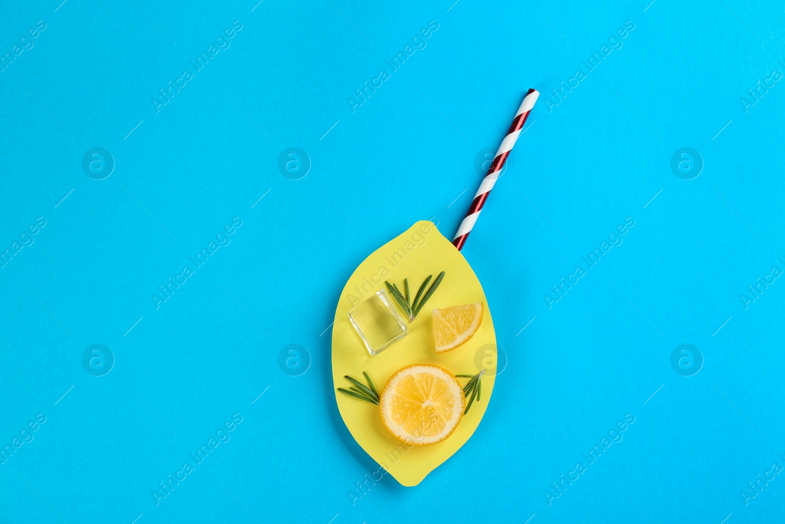 Photo of Creative lemonade layout with lemon slices on blue background, top view