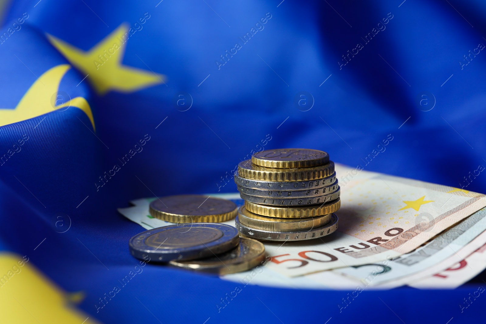 Photo of Coins and banknotes on European Union flag