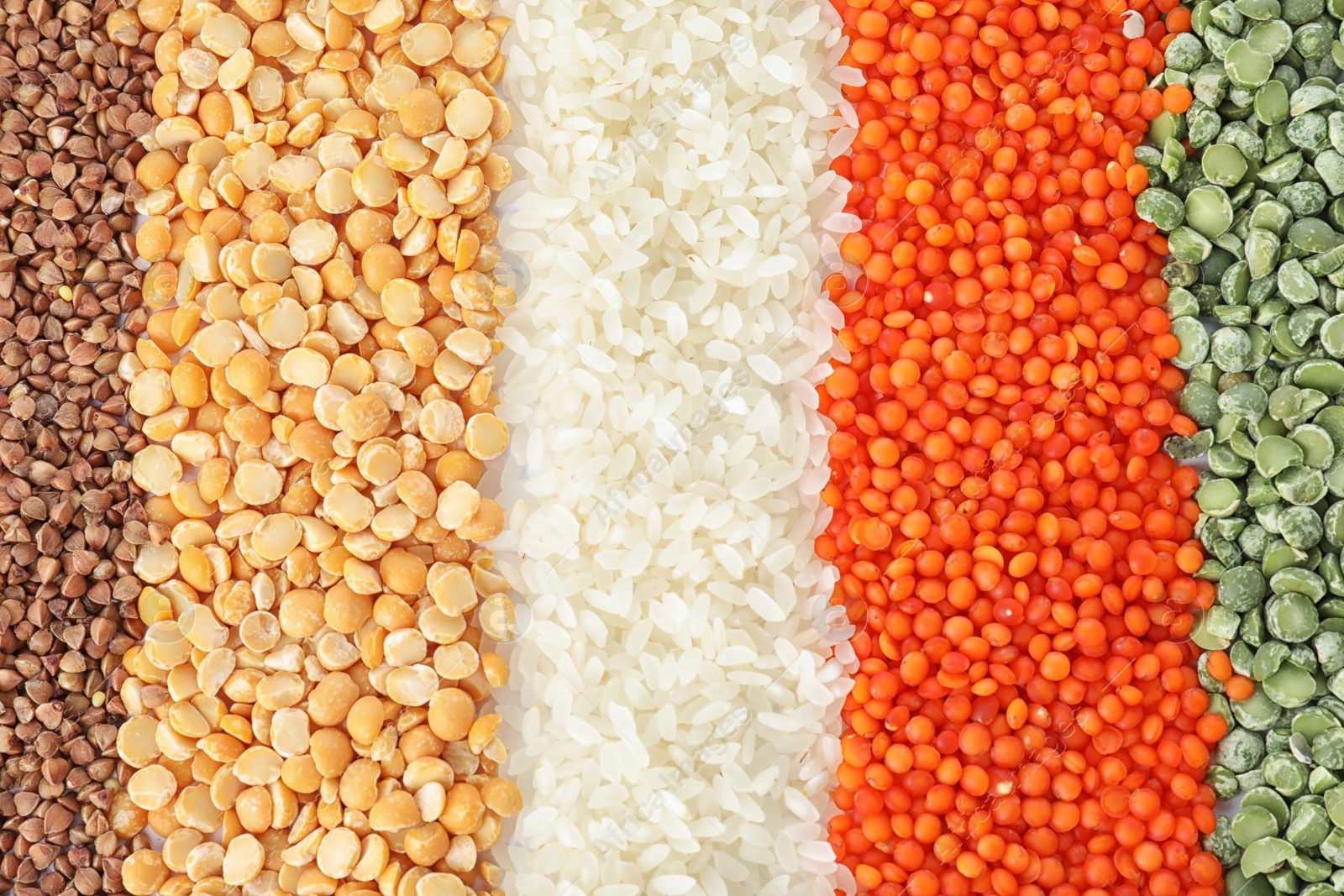 Photo of Different types of legumes and cereals as background, top view. Organic grains