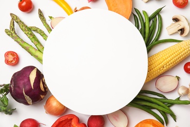 Flat lay composition with fresh vegetables and blank card for text on white background