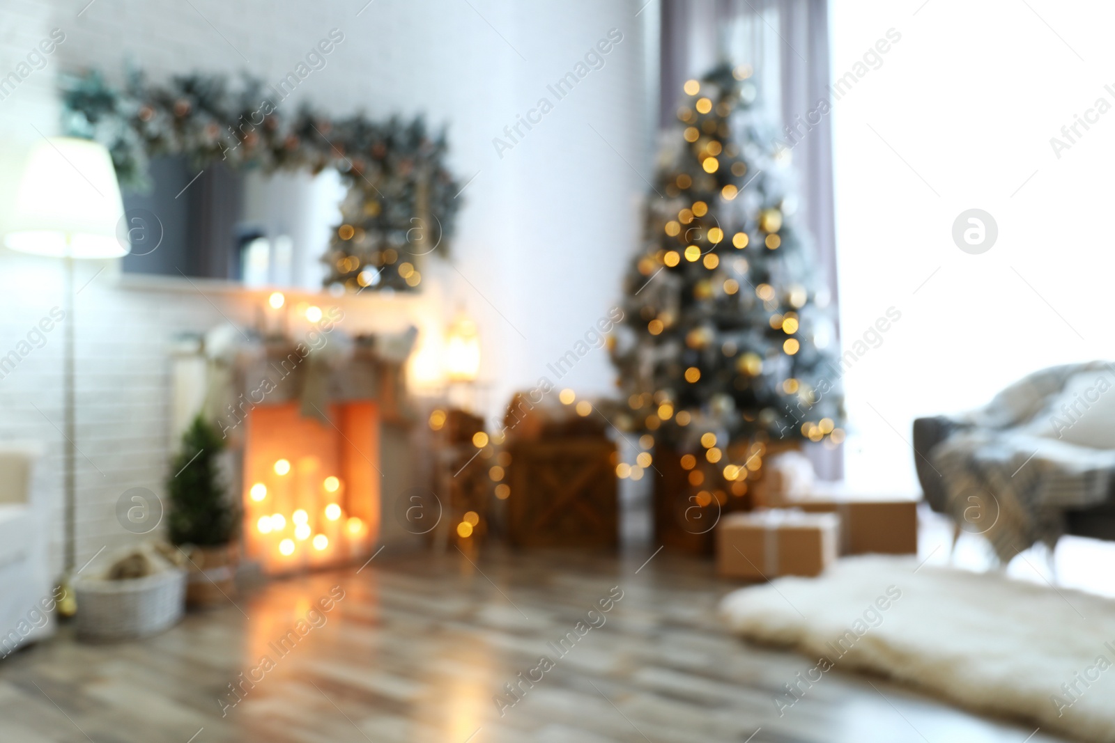 Photo of Blurred view of stylish interior with decorated Christmas tree and fireplace