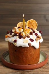 Photo of Tasty Easter cake with dried fruits and nuts on wooden table