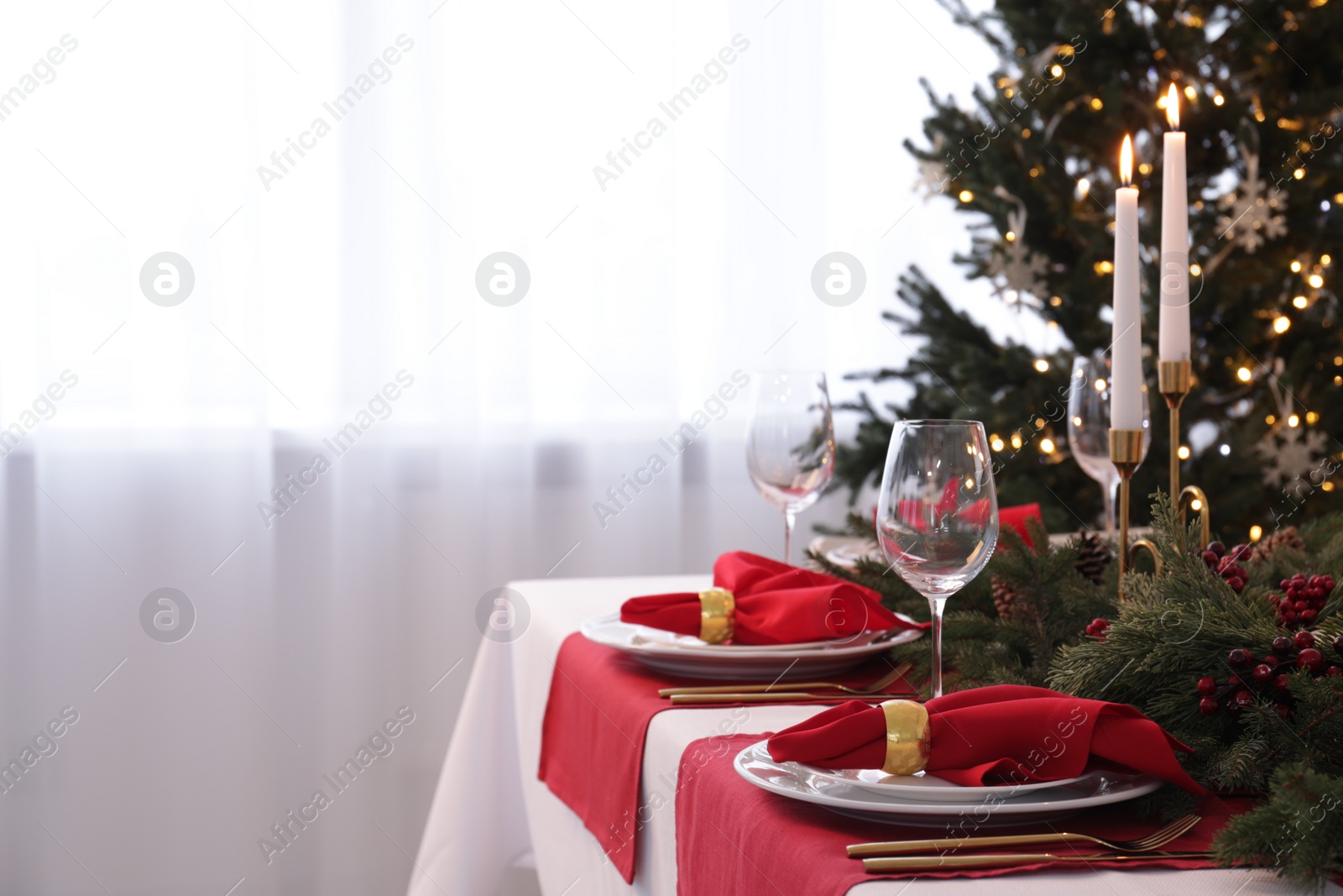 Photo of Beautiful place setting with Christmas decor on table indoors, space for text