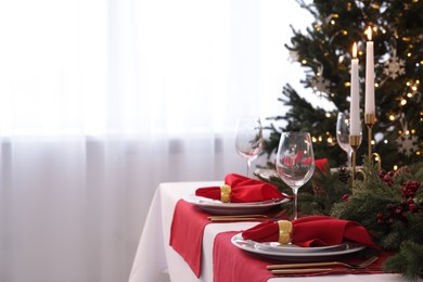 Beautiful place setting with Christmas decor on table indoors, space for text