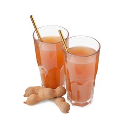 Glasses of tamarind juice and fresh fruits isolated on white