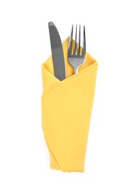 Photo of Fork and knife wrapped in yellow napkin on white background, top view