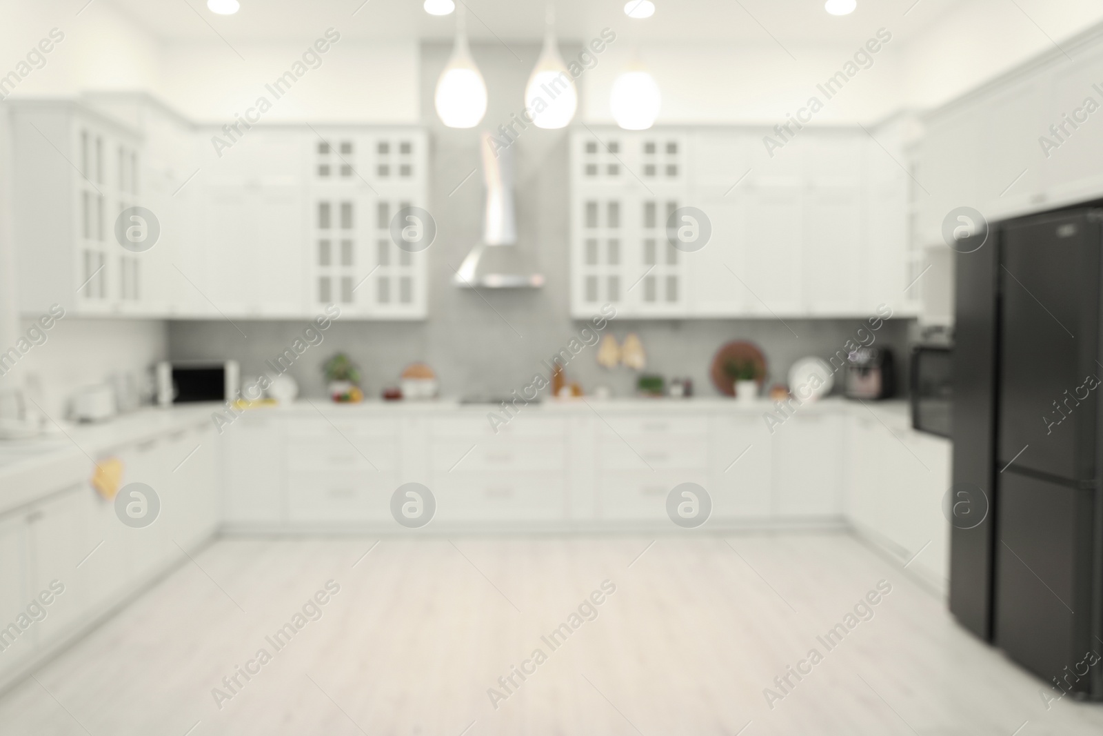 Photo of Stylish spacious kitchen with furniture, blurred view. Interior design