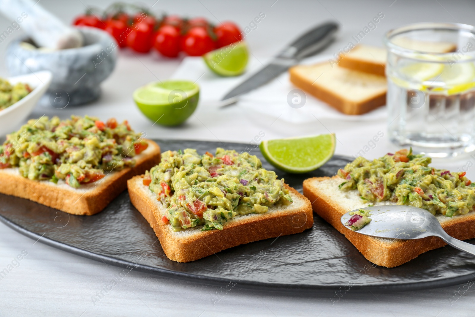 Photo of Delicious sandwiches with guacamole on white table, closeup