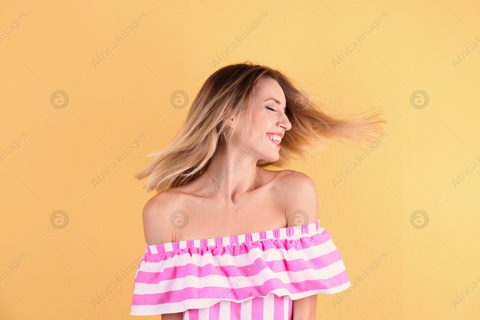 Photo of Portrait of beautiful laughing woman on color background