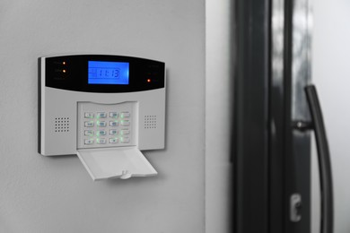 Photo of Home security system on white wall indoors, space for text