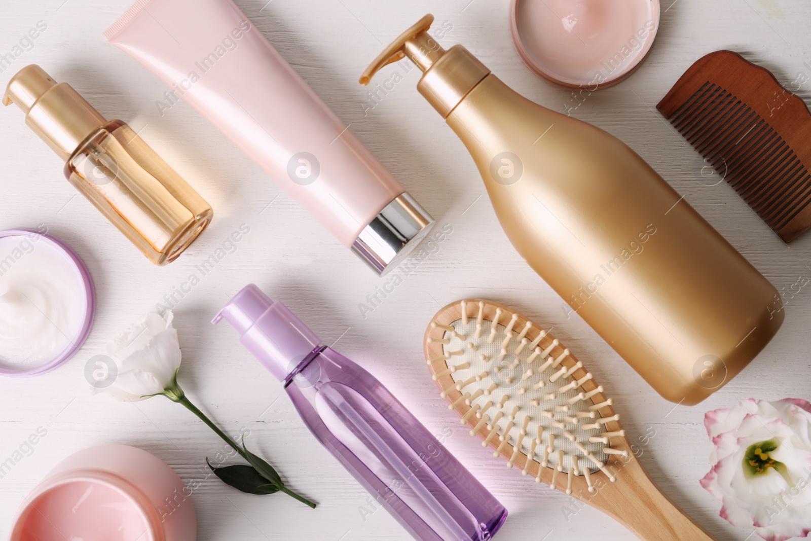 Photo of Flat lay composition with different hair products and accessories on white wooden table