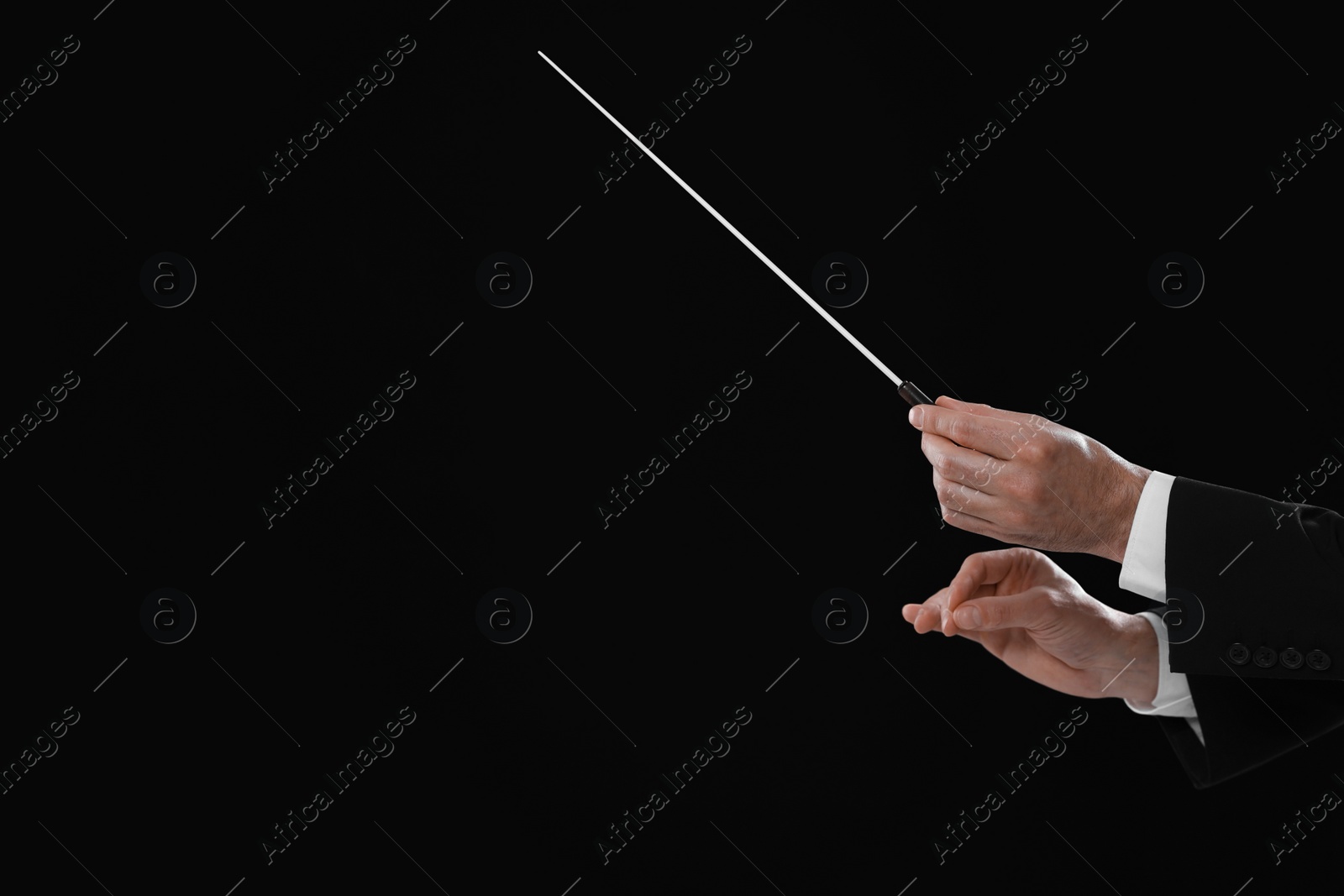 Photo of Professional conductor with baton on black background, closeup. Space for text