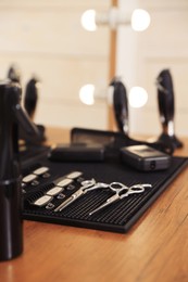 Photo of Stylish hairdresser's workplace with professional tools in barbershop, closeup
