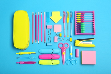 Flat lay composition with different school stationery on color background