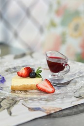 Photo of Slice of delicious cheesecake with fresh berries served on table in restaurant, closeup. Space for text