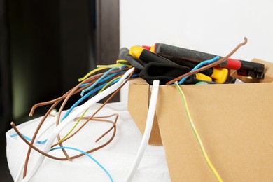 Different tools and cables in paper indoors. Installation of electrical wiring