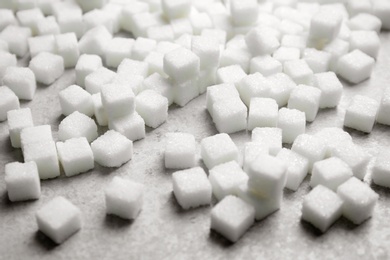 Photo of Refined sugar cubes on grey background